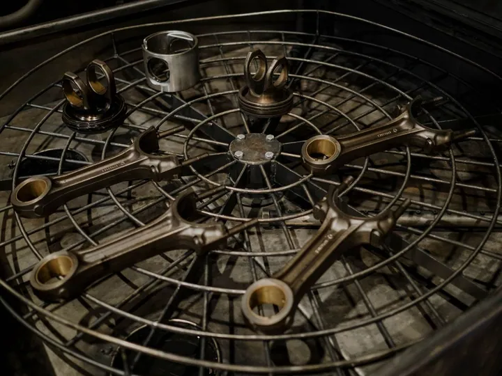 Mechanical vehicle parts arranged on a metal surface